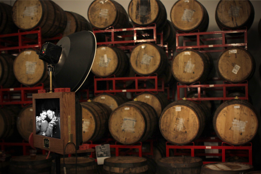 A picture of our vintage looking photo booth against the wooden barrels at Revolution Brewery.