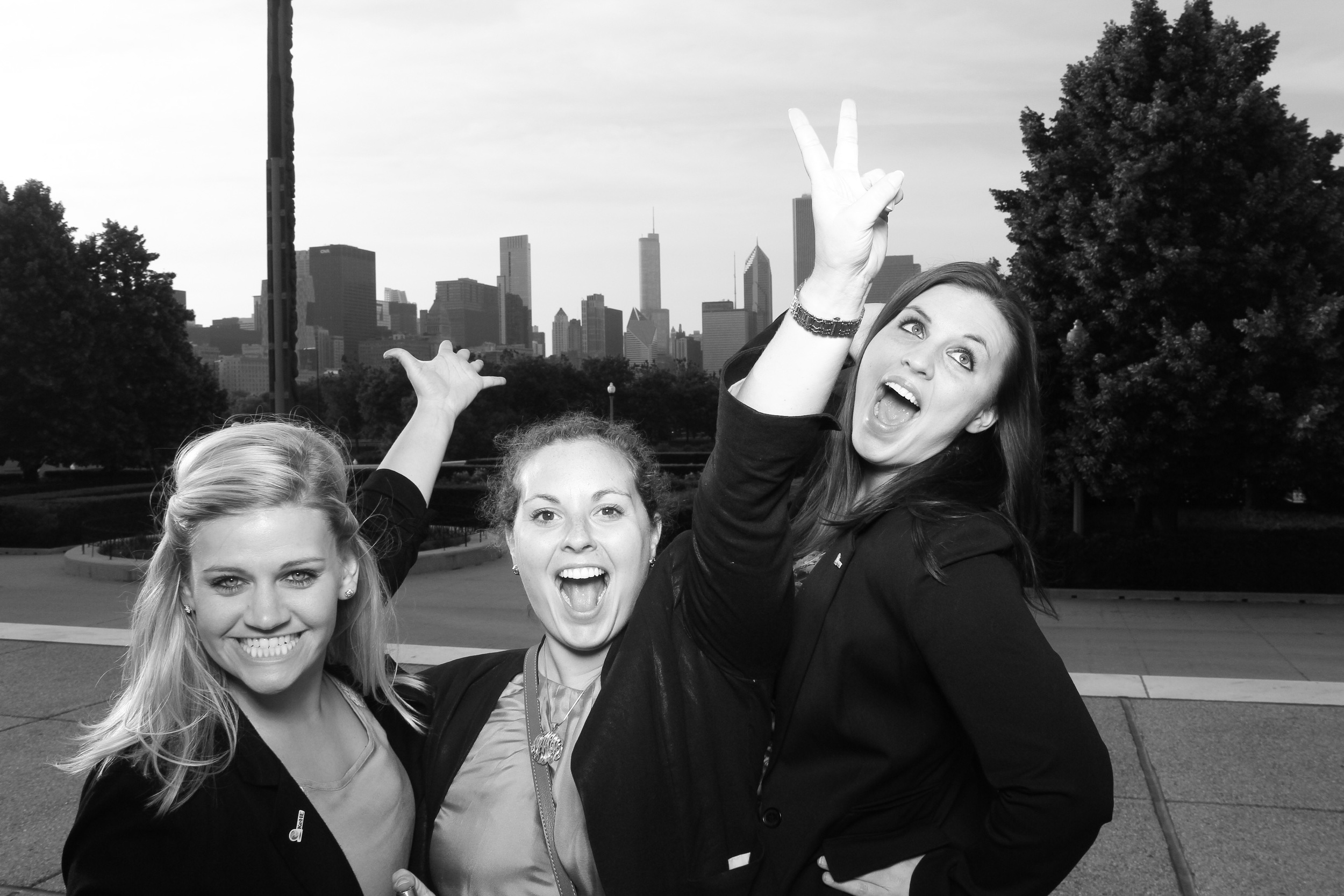 Guests pose against the Chicago Skyline for some fun pictures! Everyone looks amazing in Fotio's signature black and white style.