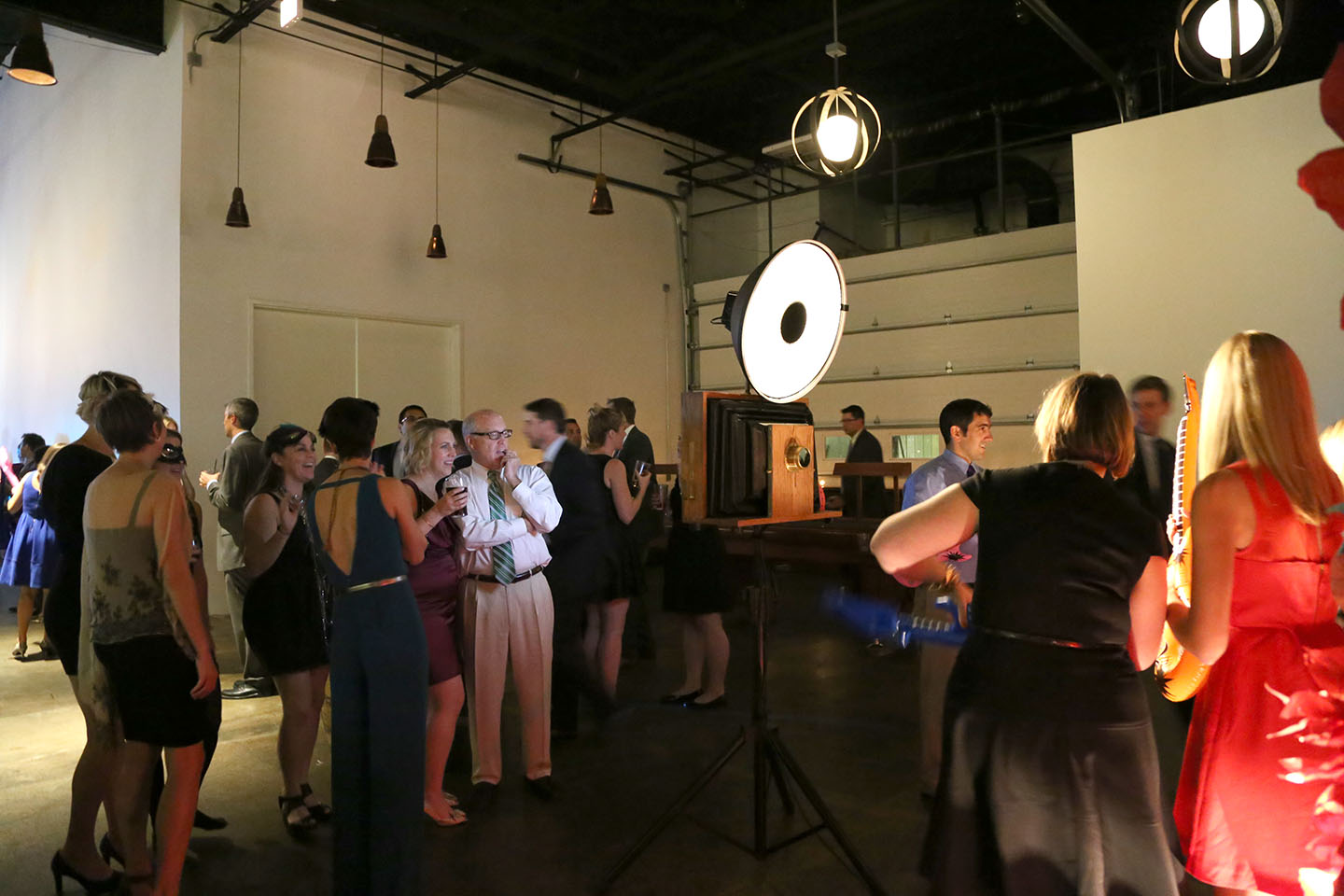 Wedding guests gather around the photo booth at Revolution Brewing!