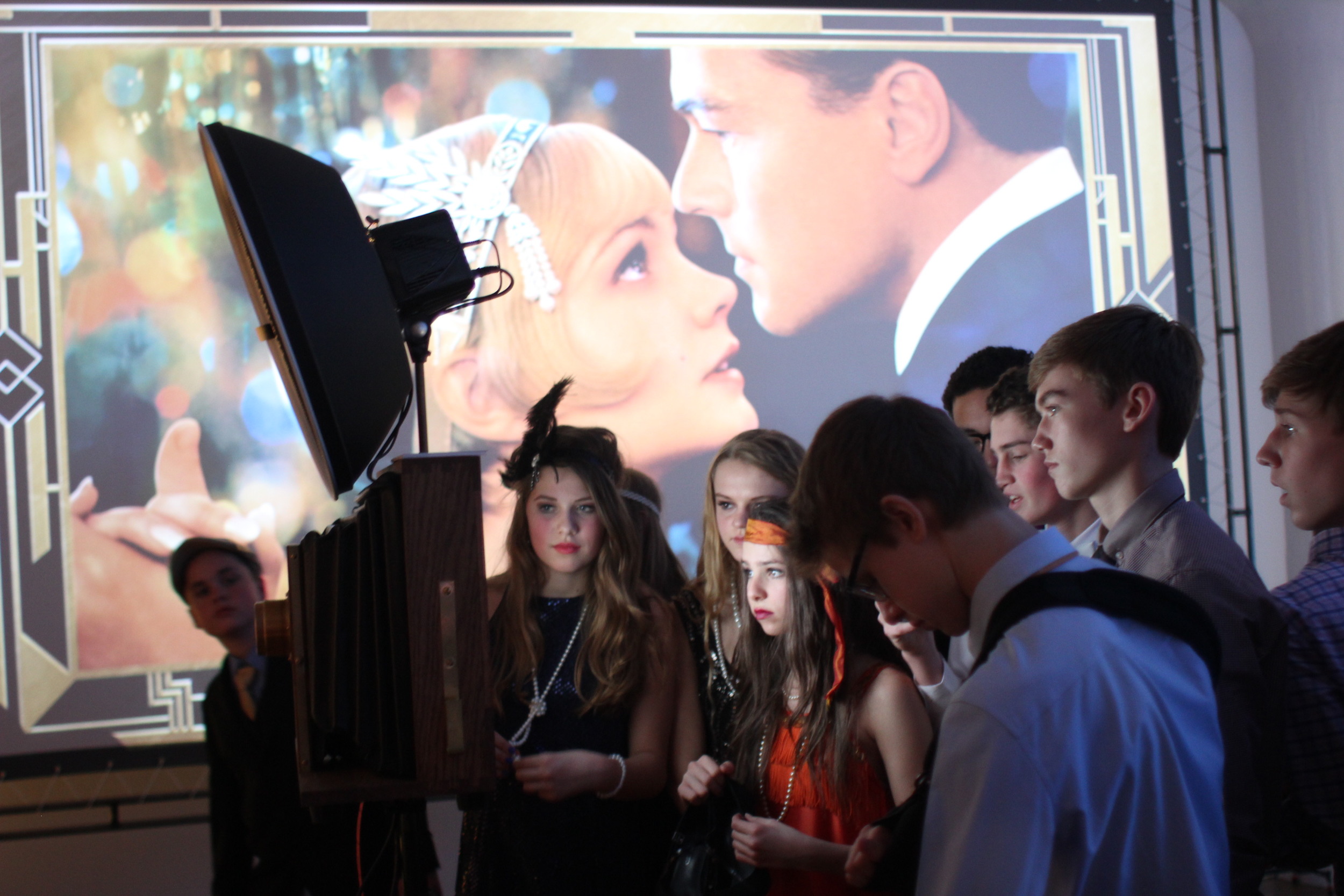 The crowd gathers around the camera view screen to watch the slideshow at Venue One! 