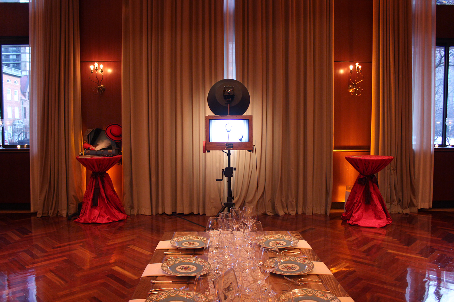 Guests gather around the back of the camera to view the photos. Also check out this beautiful table in the foreground rented from Chicago Farm Tables! 