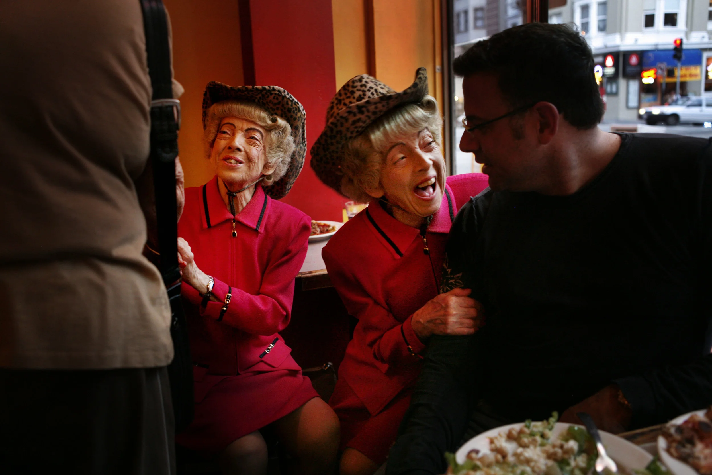  Parked in their usual window seat at Uncle Vito's pizza shop on Nob Hill, San Francisco's famous twins, Marion and Vivian Brown welcome adoring fans at their dinner table. 