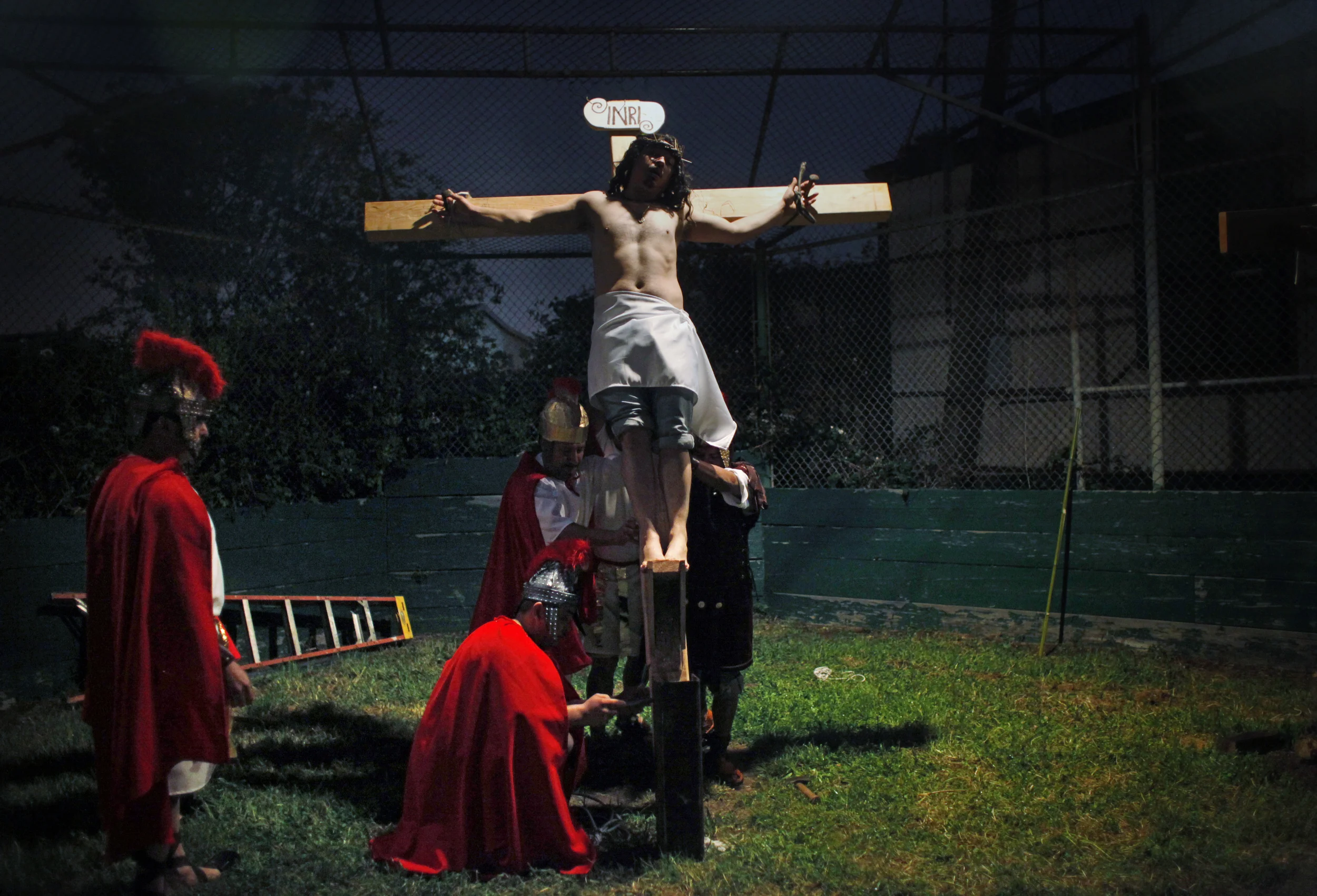  Dressed as Jesus for the production of "The Lord's Passion" at St. Paul's Catholic Church, Ignacio Ruiz, 39, two-time Jesus actor, is raised on the cross during a rehearsal. 