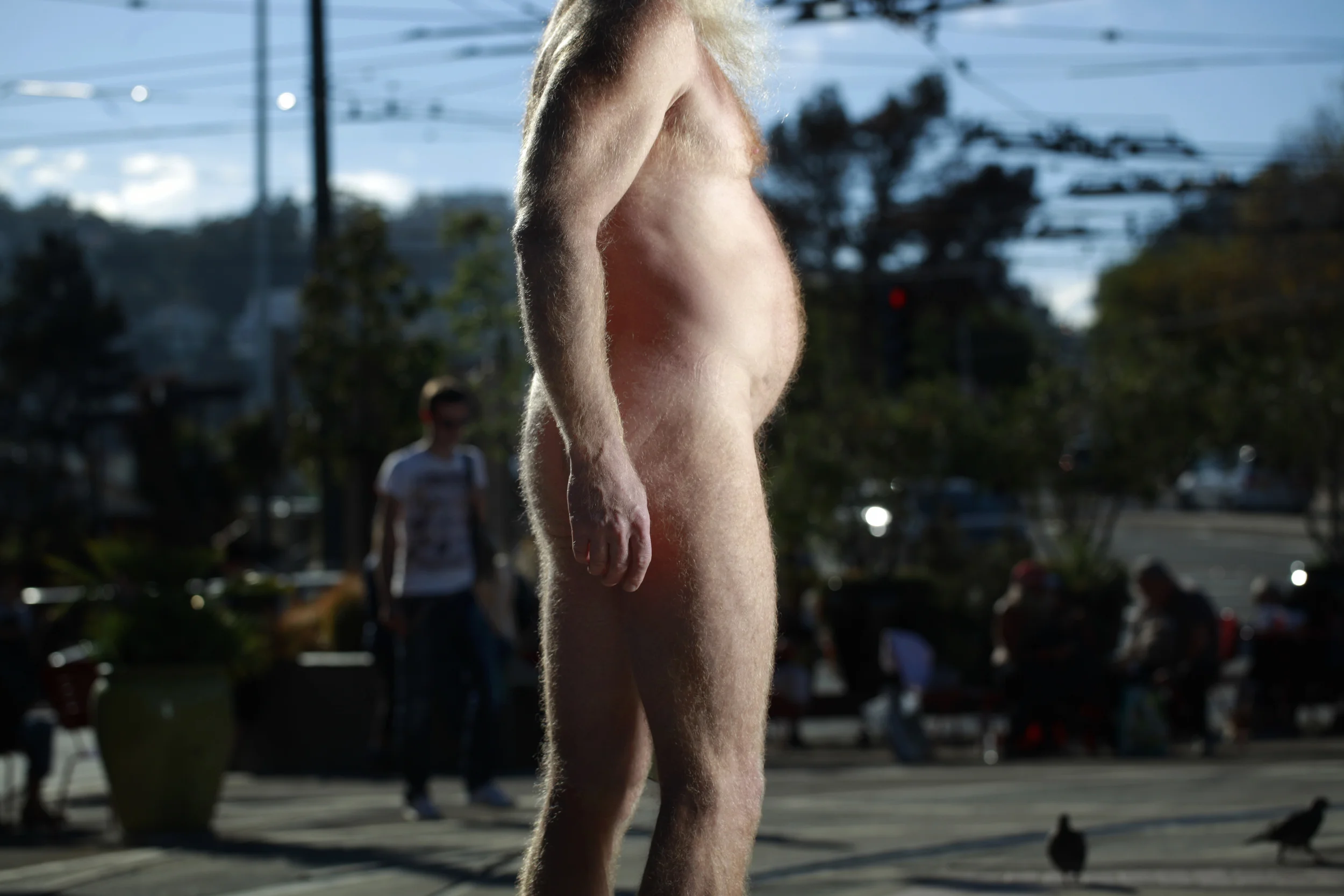  Woody Miller, 54, of San Francisco, stands naked at the corner of Castro and Market Streets in protest of a city ordinance banning public nudity. 