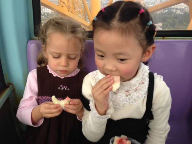 Once we got on the ferris wheel, my friend pulled an apple, a pear, a knife, and a plastic container out of her bag. Our local friends seem to always have fresh fruit handy for snacking anytime there's an opportunity. No wonder many of them are so h…