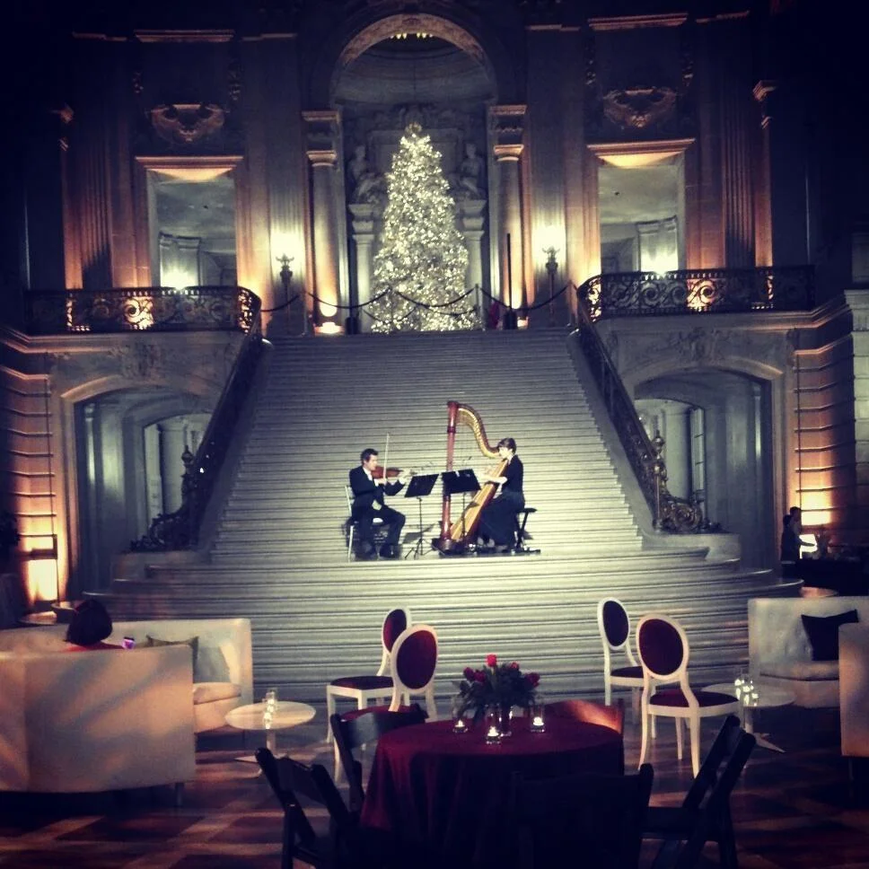 GOOGLE hires a violinist and harpist to perform at their 2012 holiday party inside San Francisco City Hall's rotunda