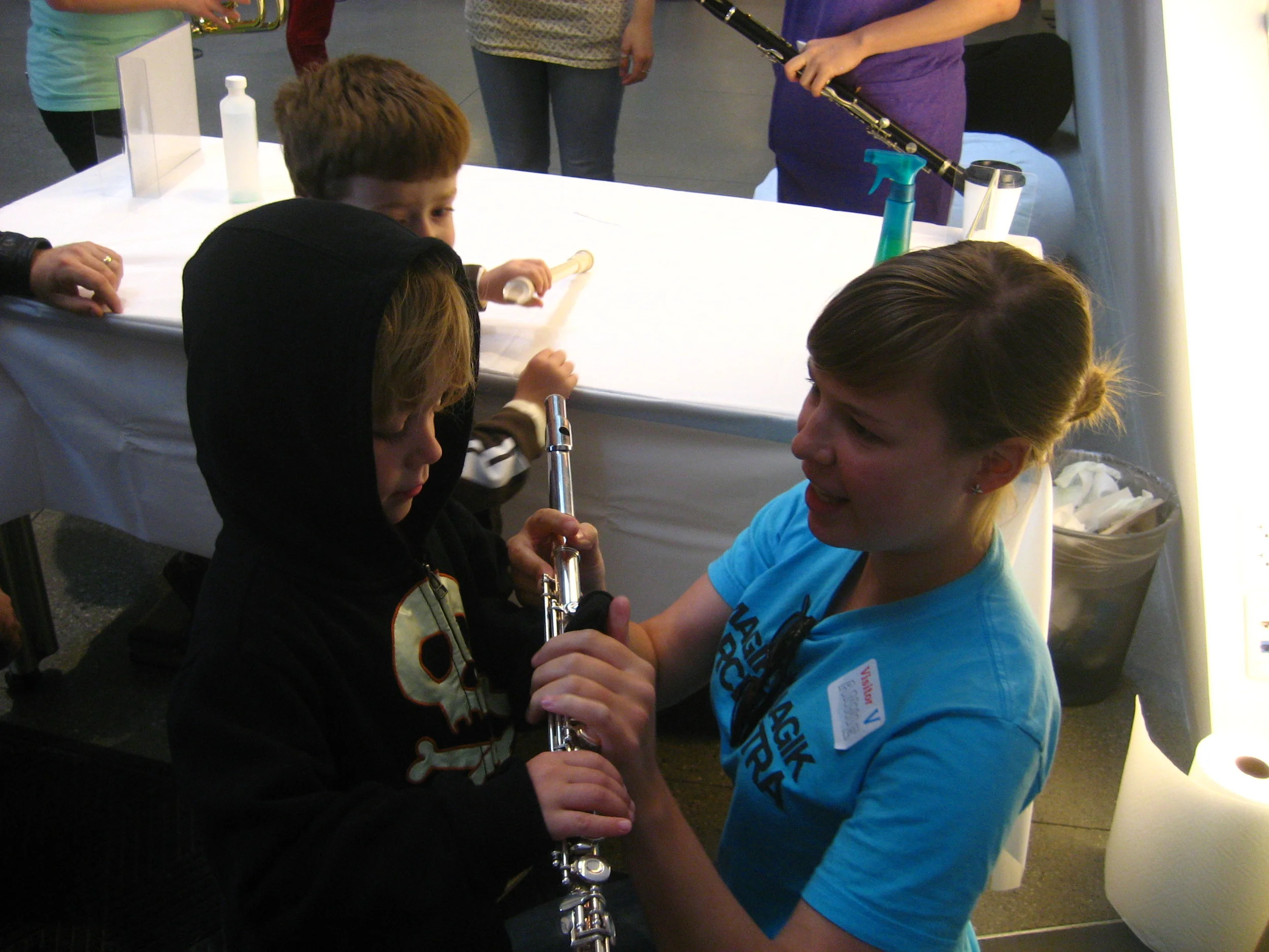 Annie teaches how to make sounds on the flute