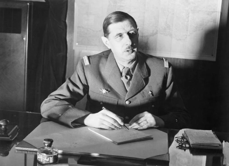 1. Commander_of_Free_French_Forces_General_Charles_de_Gaulle_seated_at_his_desk_in_London_during_the_Second_World_War._D1973.jpg