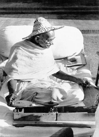 Here Gandhi is wearing a Noakhali hat whilst spinning at Birla House, New Delhi