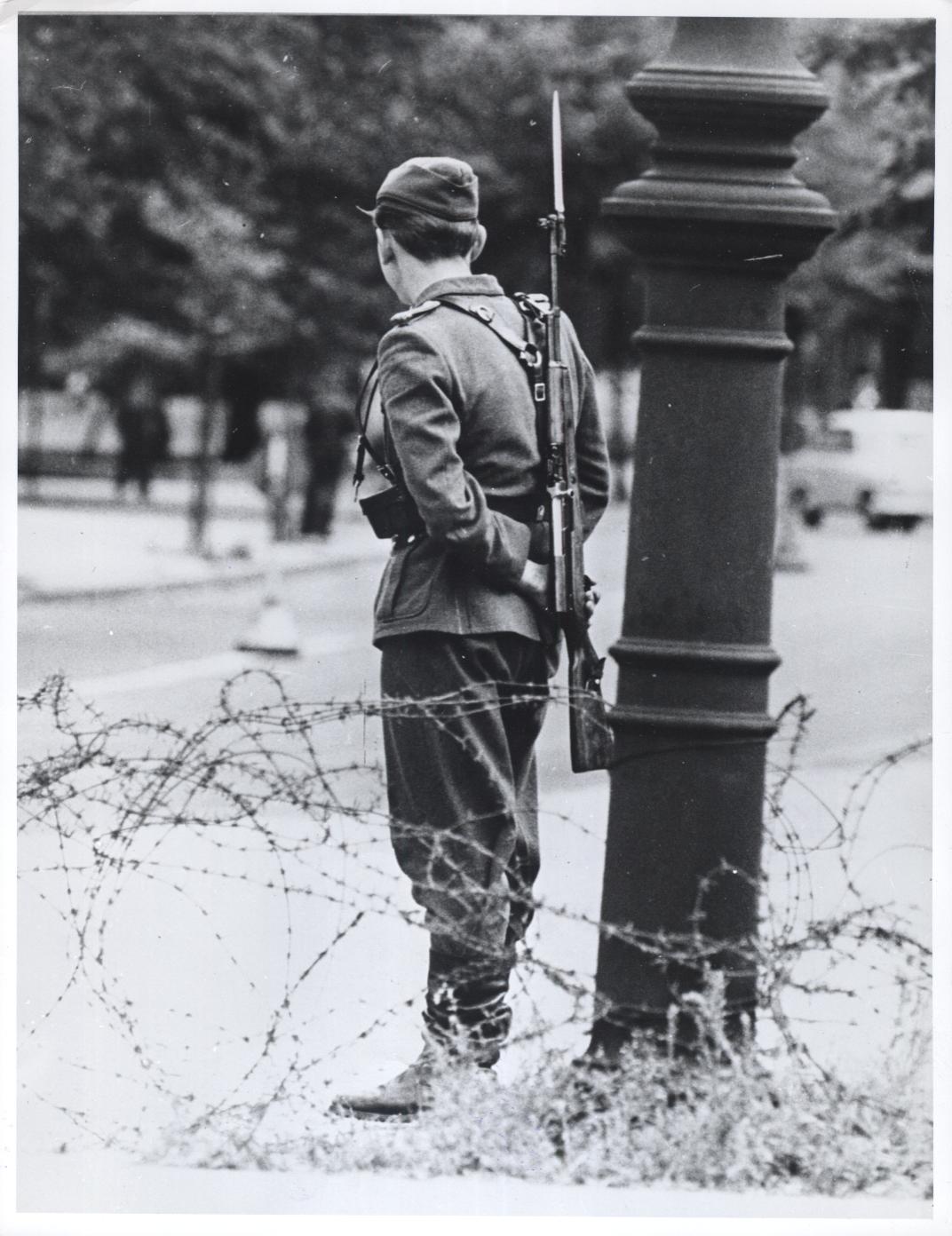 An East German soldier guarding the newly-formed Berlin Wall in August 1961.
