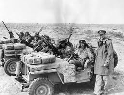 Two LRDG patrols at a rendezvous with their typical vehicles.