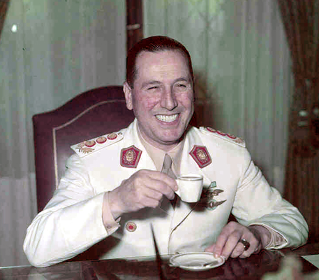 General Juan Peron in uniform, drinking coffee.