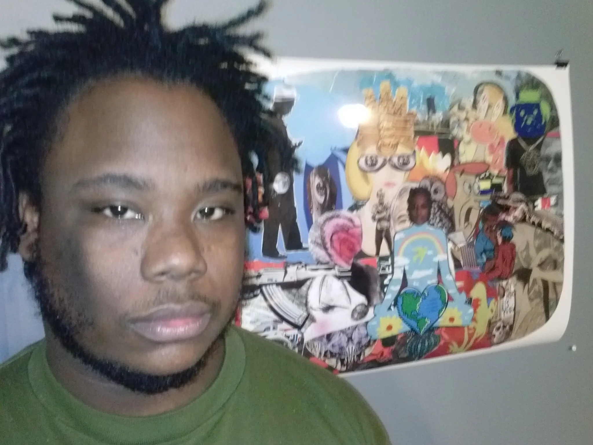 Grits Capone in front of a collage he created for Art on the Walls , a show curated by DS Kinsel and currently up in the Greater Pittsburgh Arts Council offices in Downtown Pittsburgh. Photo provided by Grits Capone. 