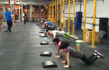 Coach Mike and Katie teaching some push ups to our 6pm class