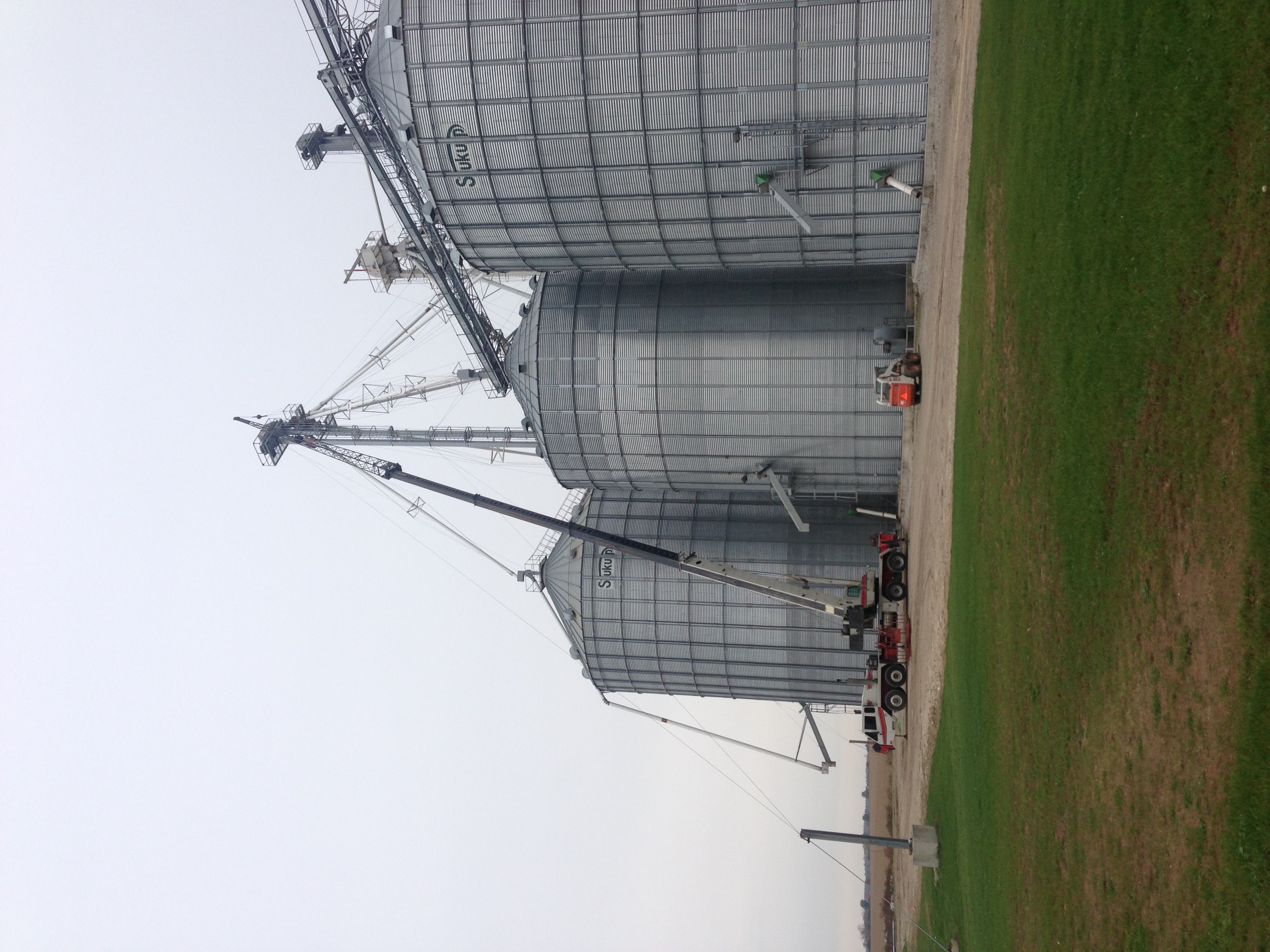 Spout for grain bin being hoisted by 75 ton crane