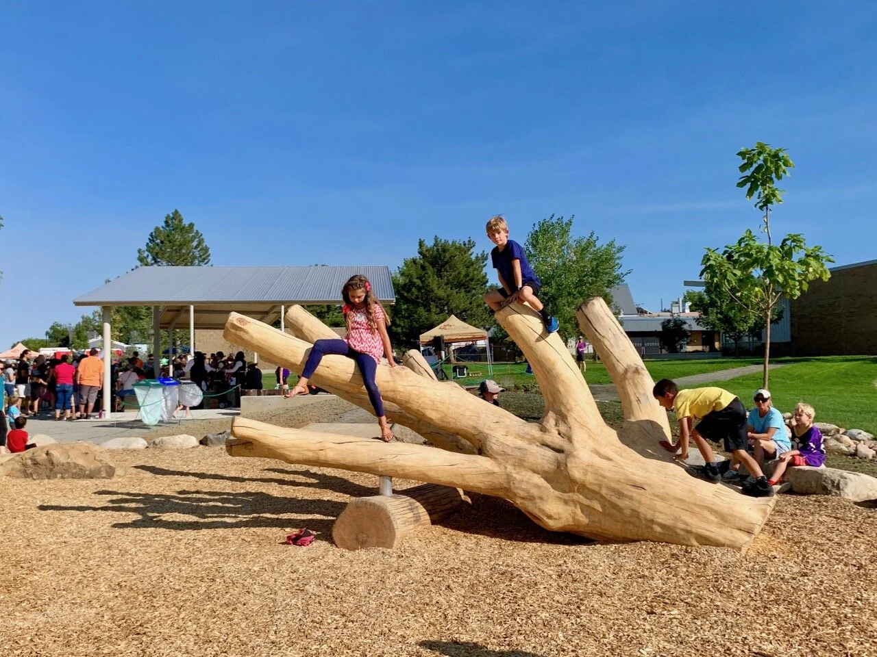 Kids p[aying on tree log at Nature Discovery Area & Inspire Trail in Lafayette, Colorado