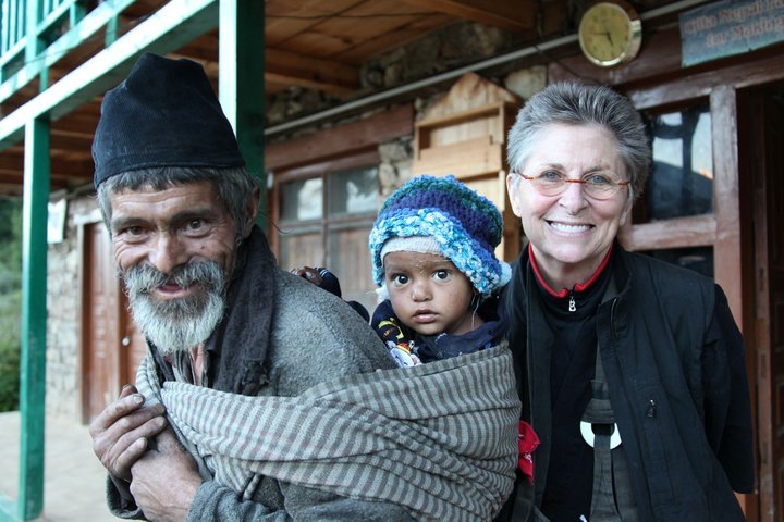 Roshi Joan at her Nomad's Clinic in Humla, Nepal, with a Nepali man and his baby