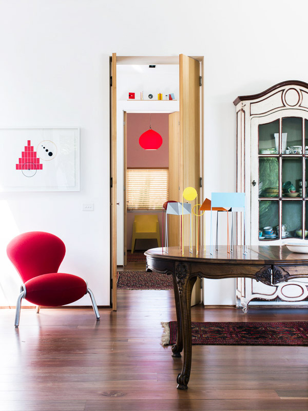 Looking from living area through to study. Work on paper (left) and small sculptures on table all by Peter D Cole. Embryo chair by Mark Newson. French provincial 19th Century painted vitrine. Photo - Sean Fennessy , production – Lucy Feagins / The Design Files.