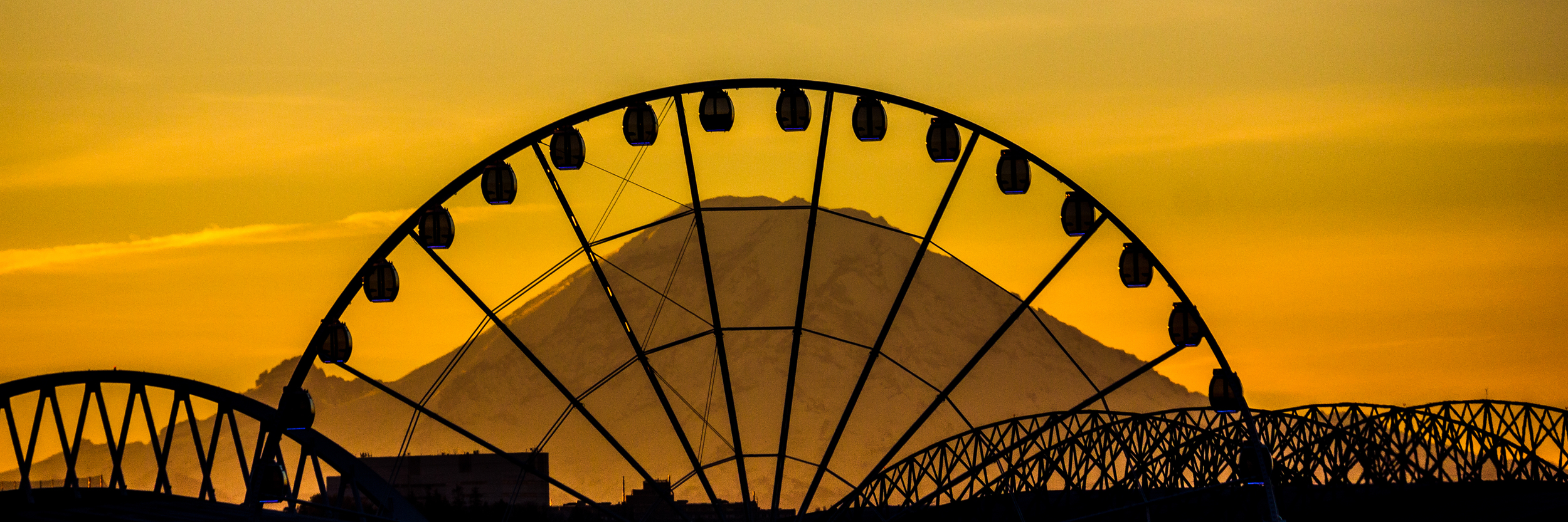 Mt. Rainier behind Seattle's Great Wheel (surrounding by the stadiums)