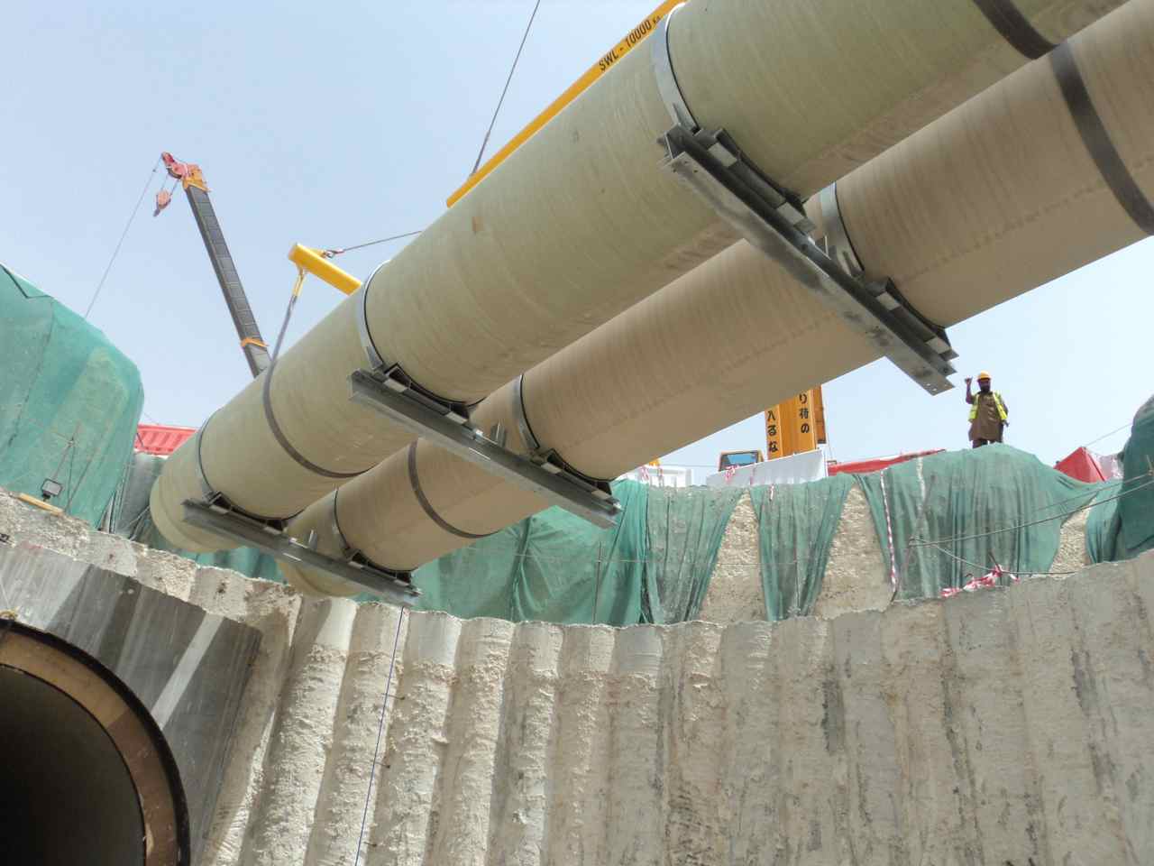 Pipes being lowered into the pit