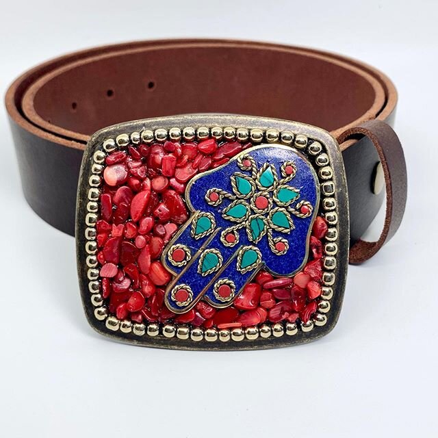 Everyone could use a little positive energy. The Hand of Fatima is an ancient talisman that symbolizes feminine power. This buckle features a vintage Tibetan hand with inlaid turquoise, red coral and lapis, surrounded by red coral and gold beads. Sho