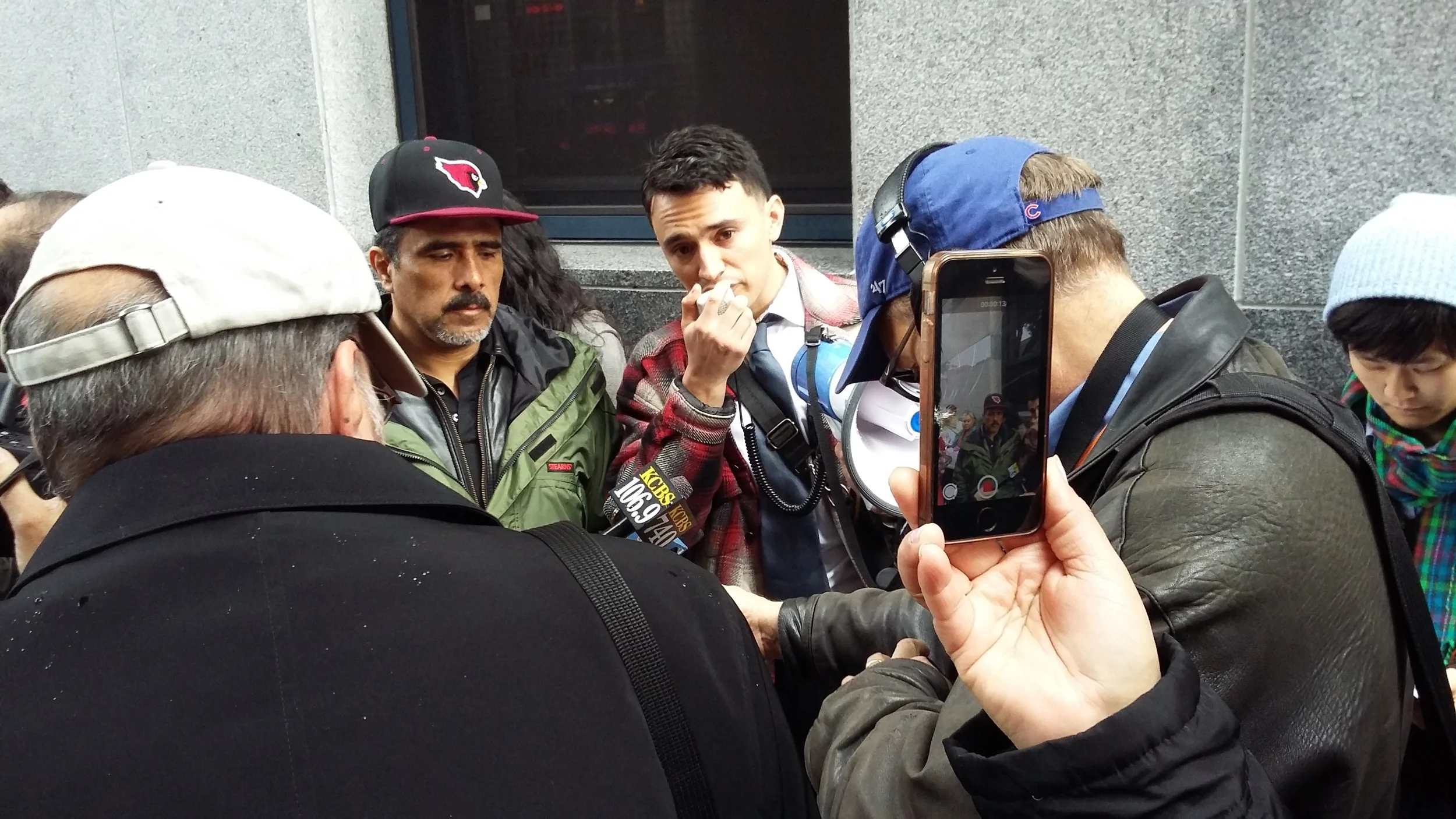 Ernesto on the left with attorney Luis Angel speaking with media to educate community members about ICE raids in San Francisco. 
