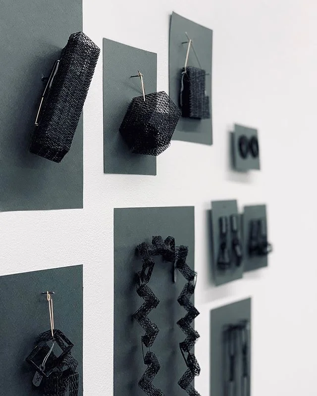 TACTILE. Took a break from the people watching and popped into a jewelry show. These black beauties caught my eye. I found these pieces to be compelling but I don&rsquo;t know why.