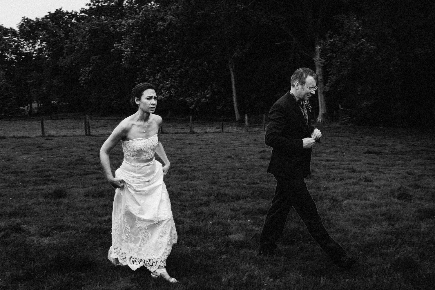 Bride and groom in a field.