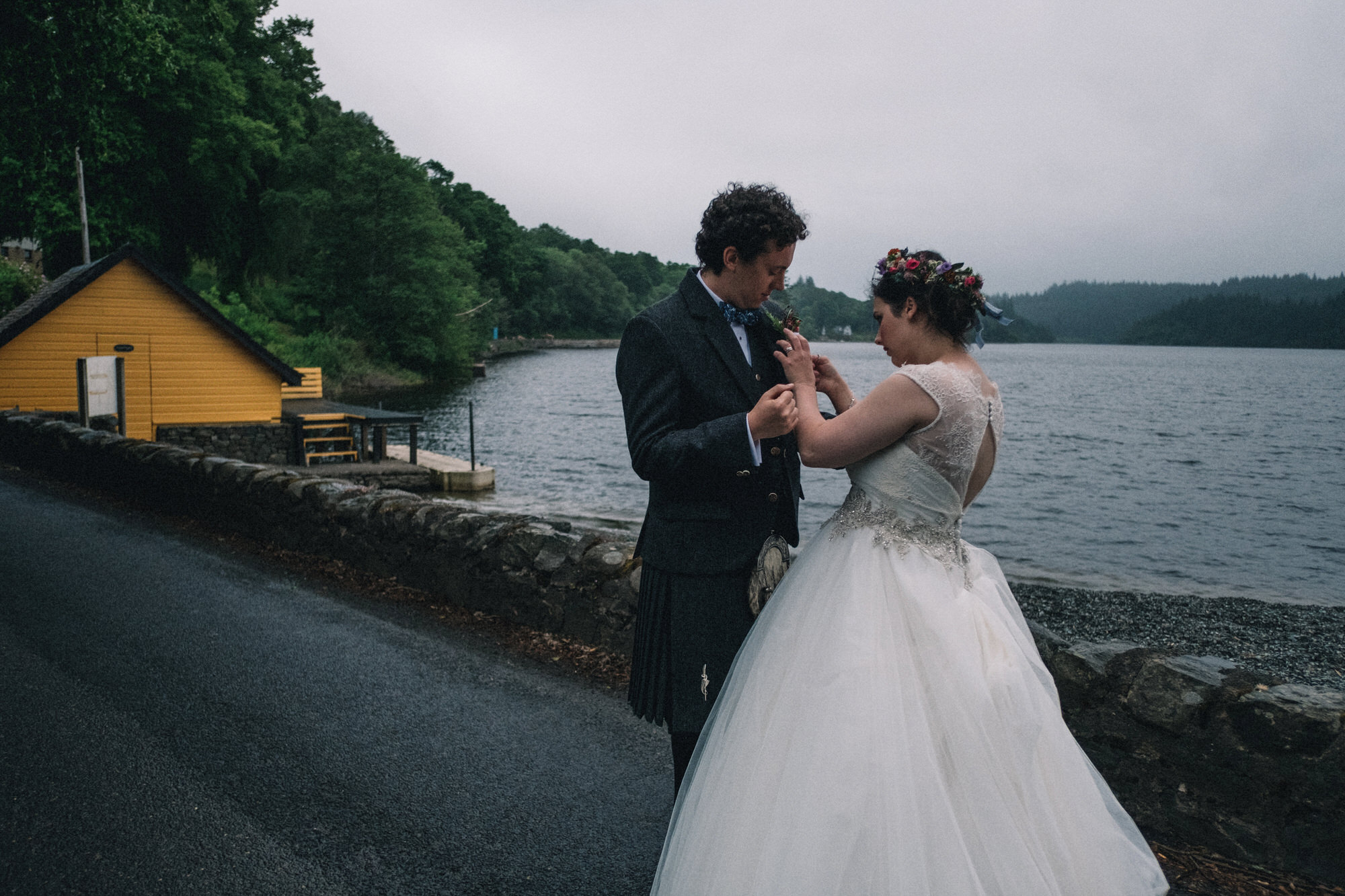 Bride helps straighten groom's button hole