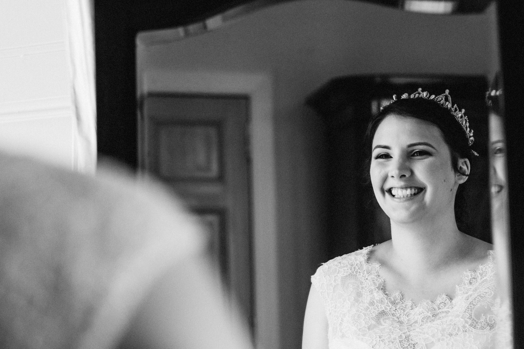 Bride smiling in the mirror