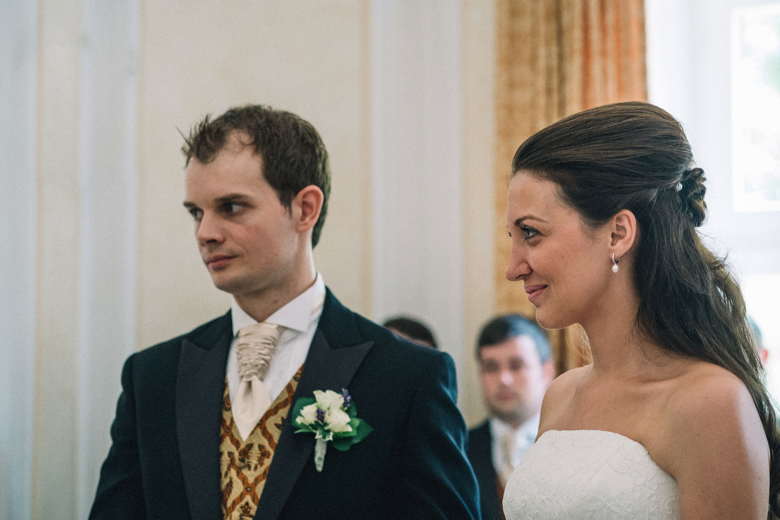 Bride + groom look to their celebrant