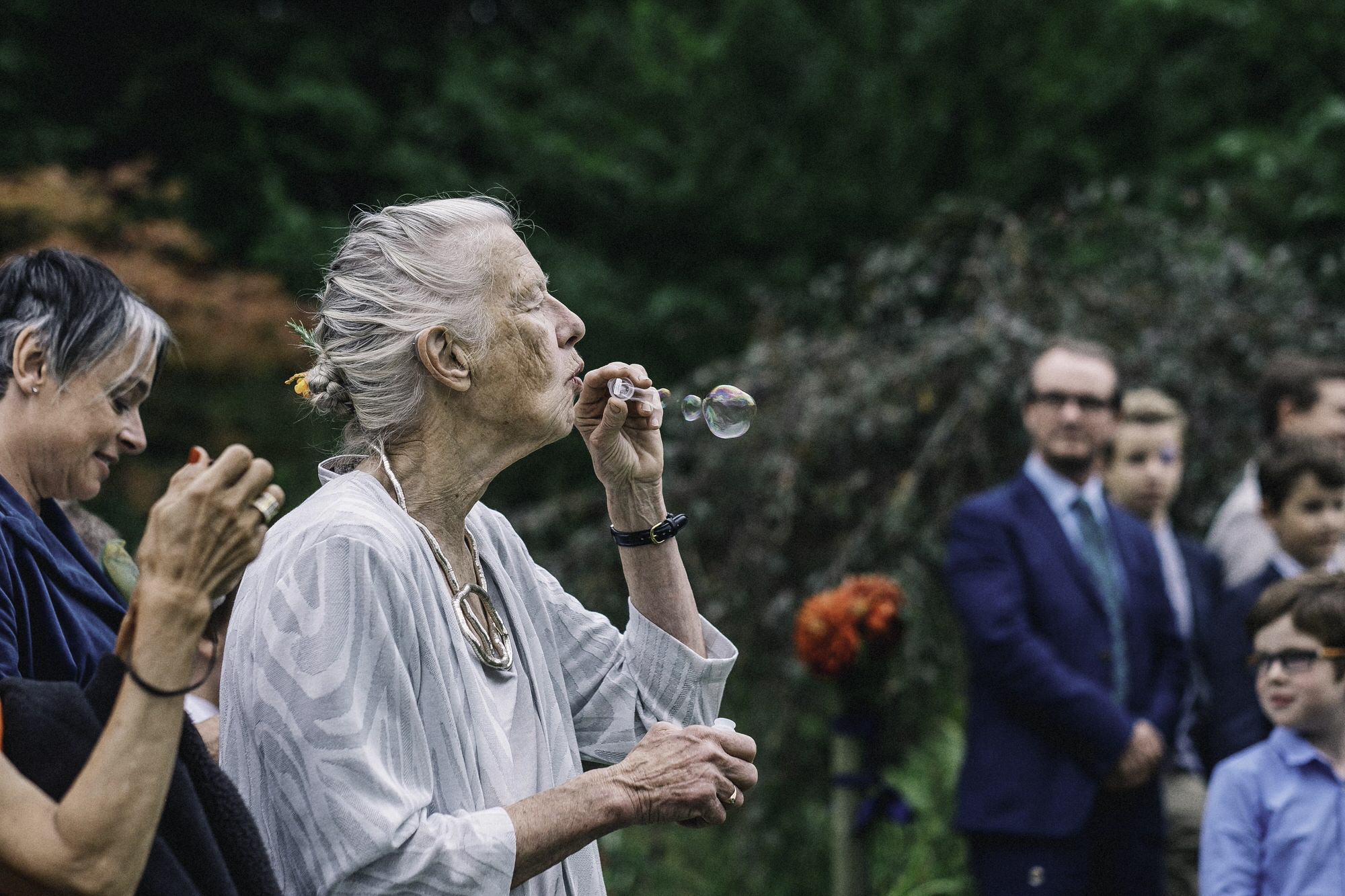 Mother of groom blowing bubbles
