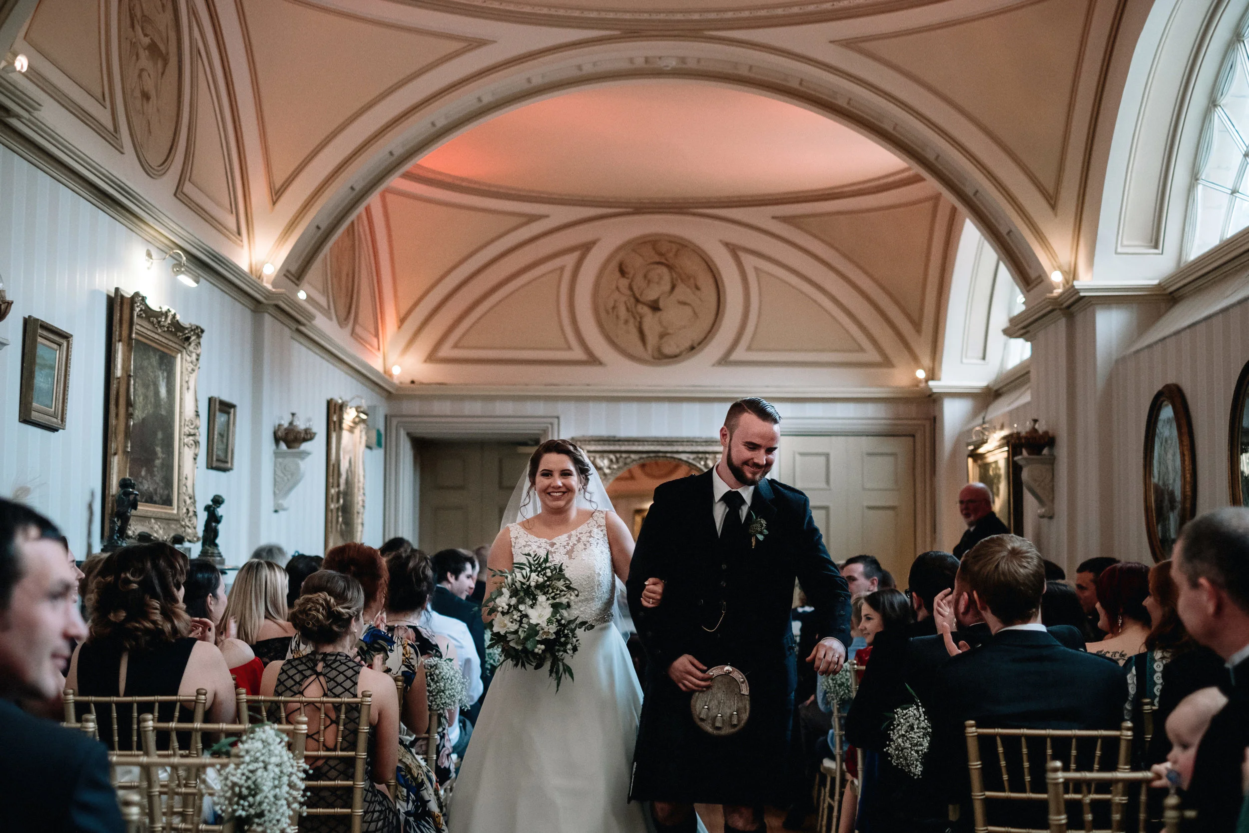 Bride and groom walking down the aisle together