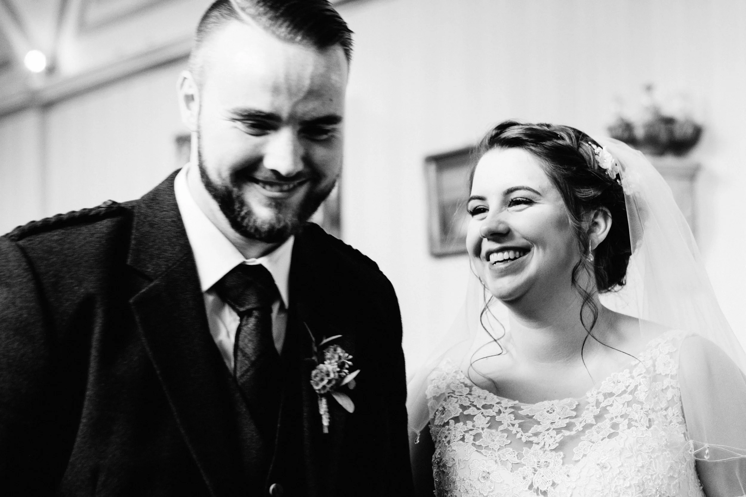 Bride and groom laugh during their ceremony