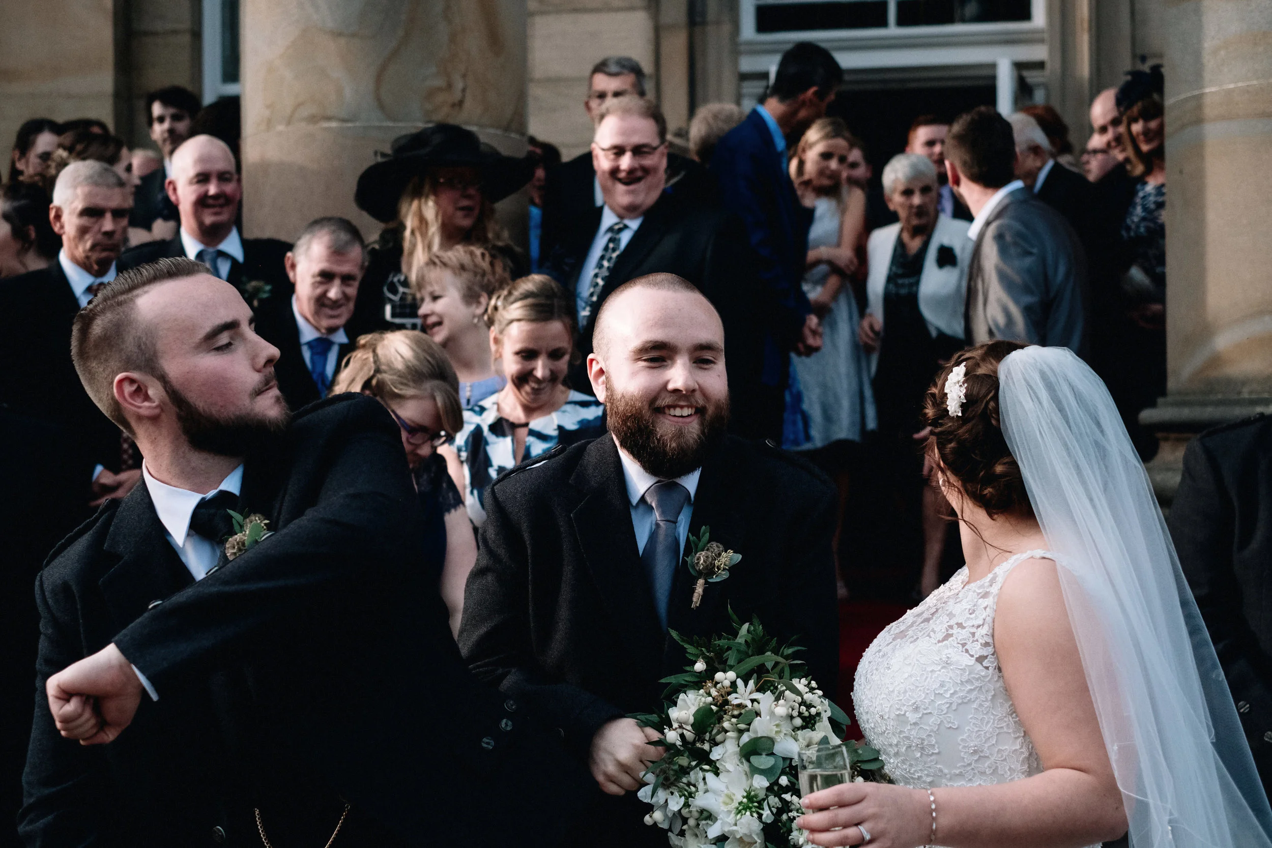 Bride and groom mingle outside with their guests