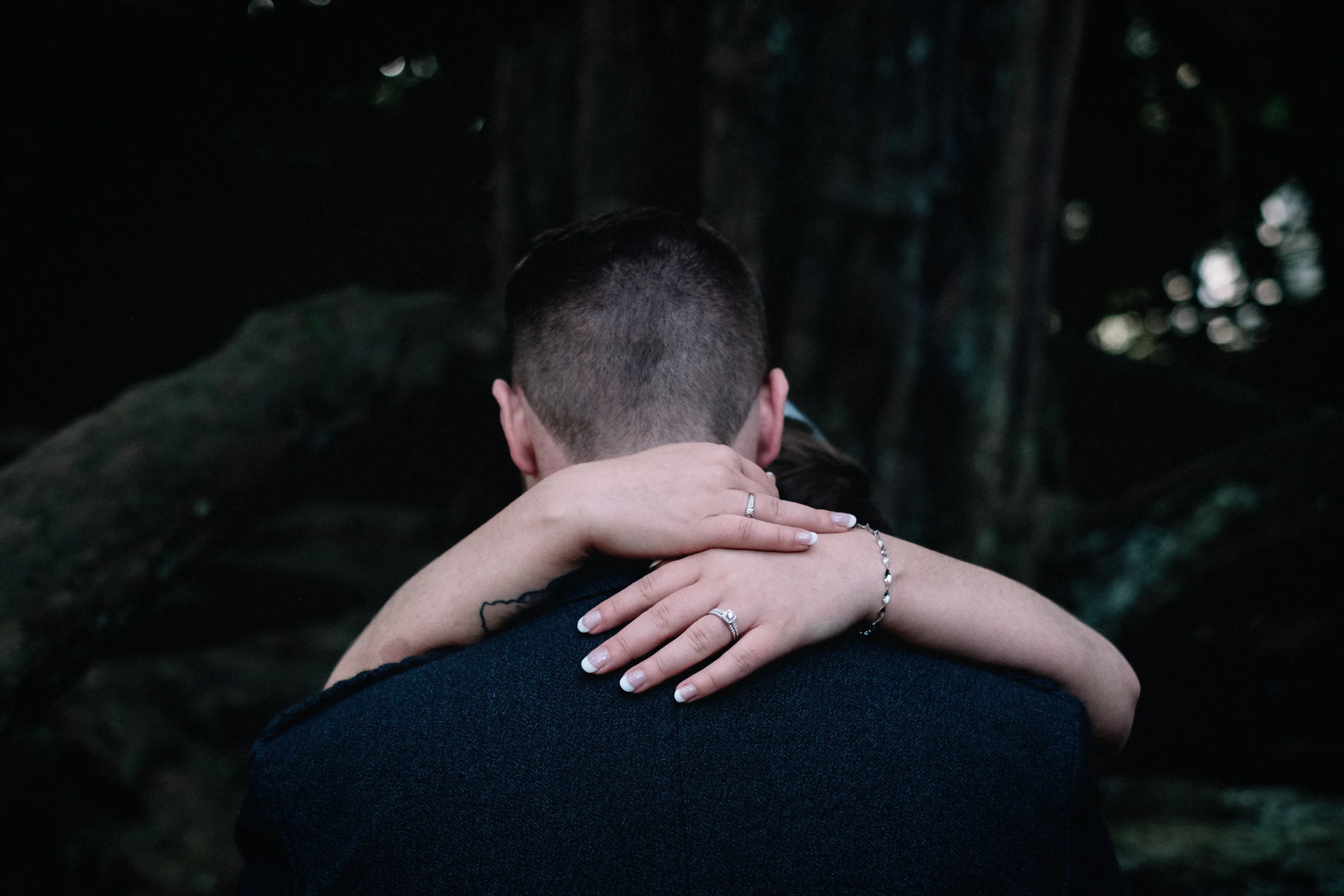 Bride and groom embrace in a Scottish forrest