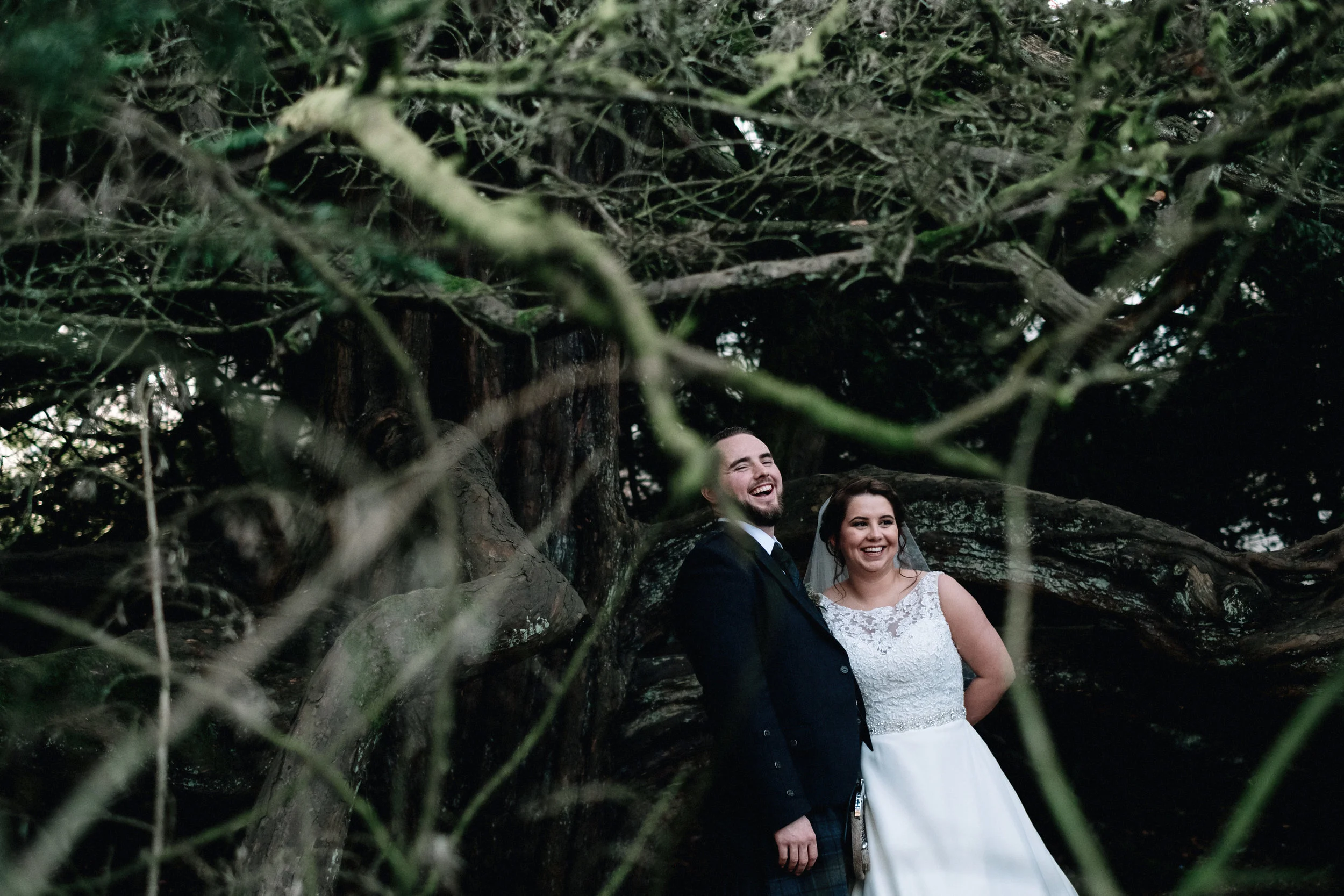 Laughing bride and groom in a forrest