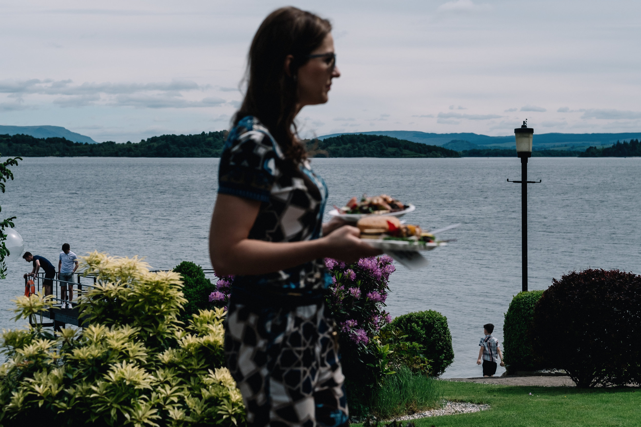 Lady walking with plate of bbq