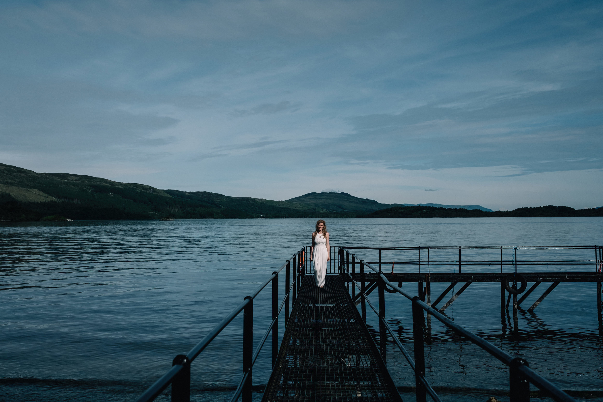 Bride stands on pier