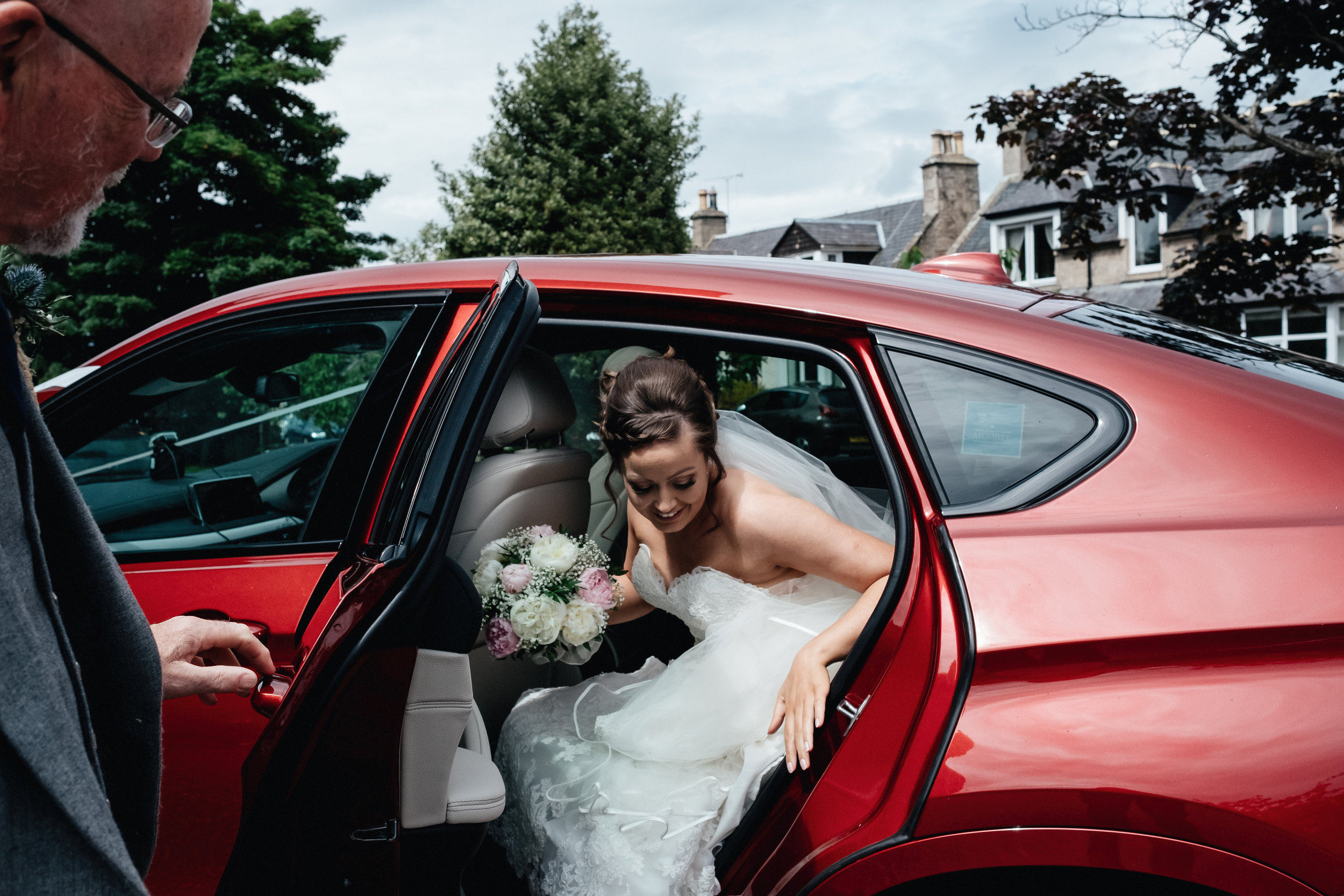 Bride getting out of car