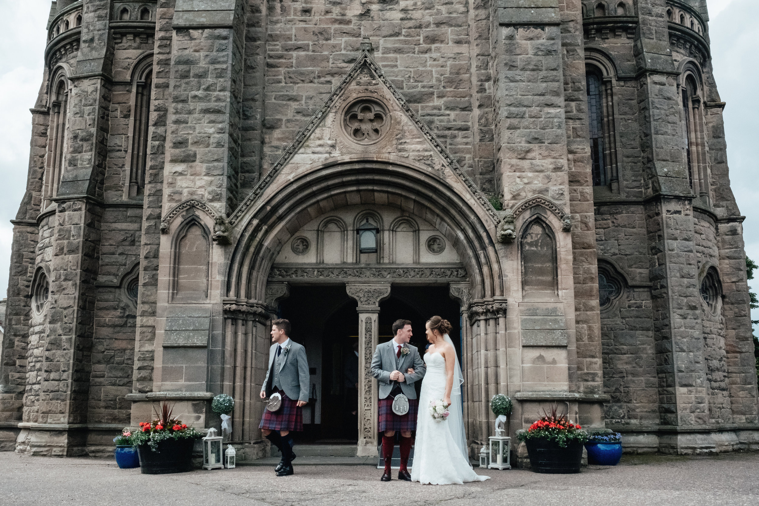 Bride and groom standing outside church