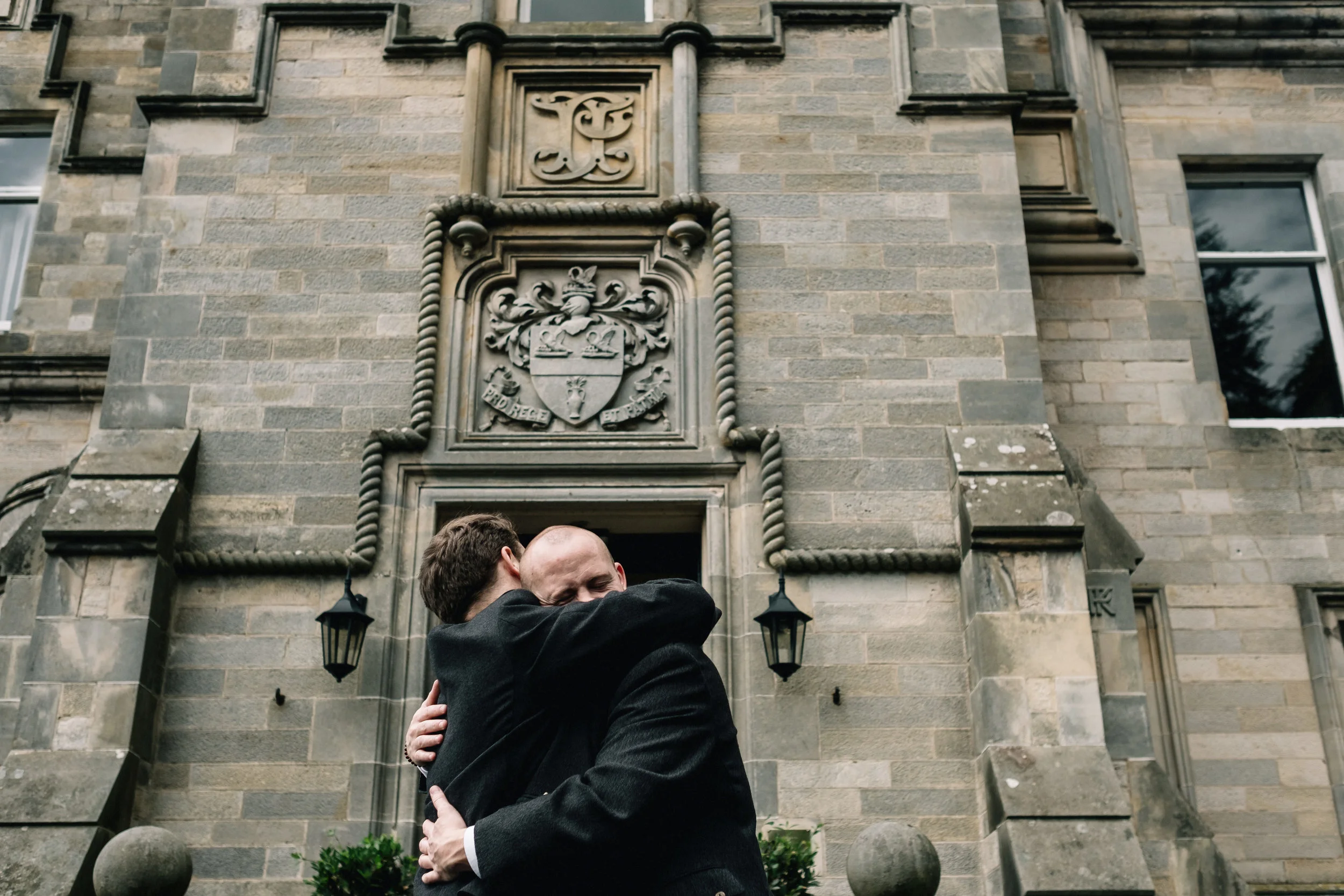 Embrace between groom and best man