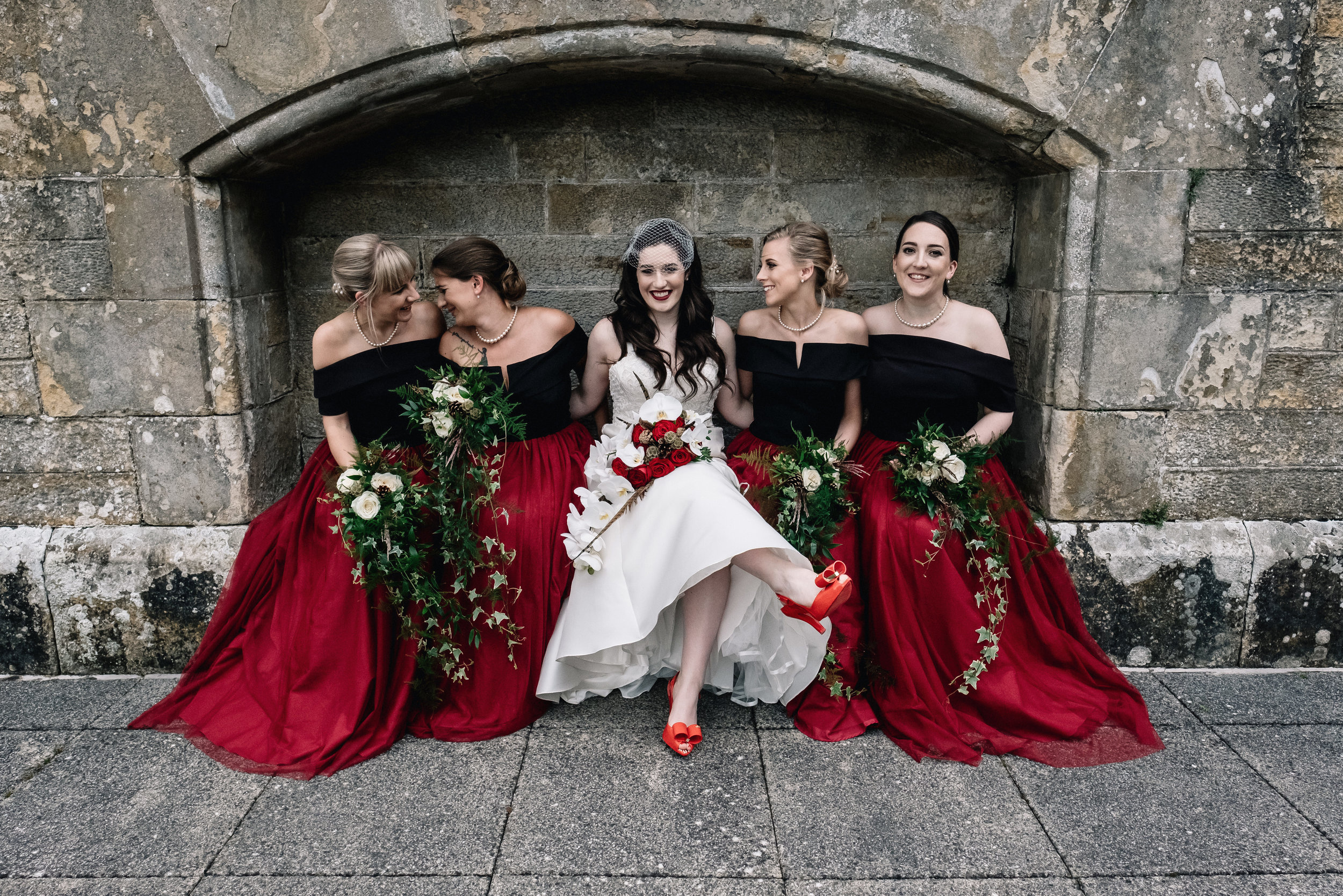 Bride sits with bridesmaids