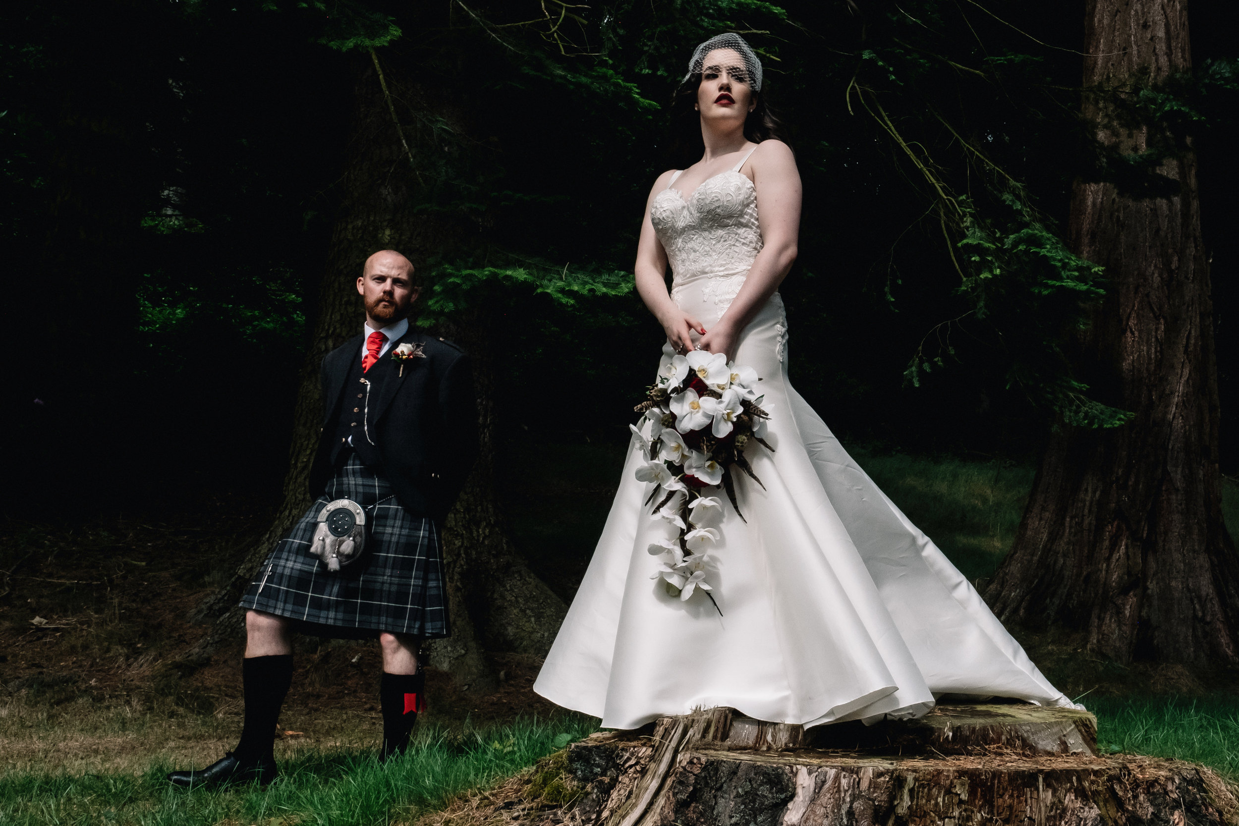 Bride and groom stand in forrest