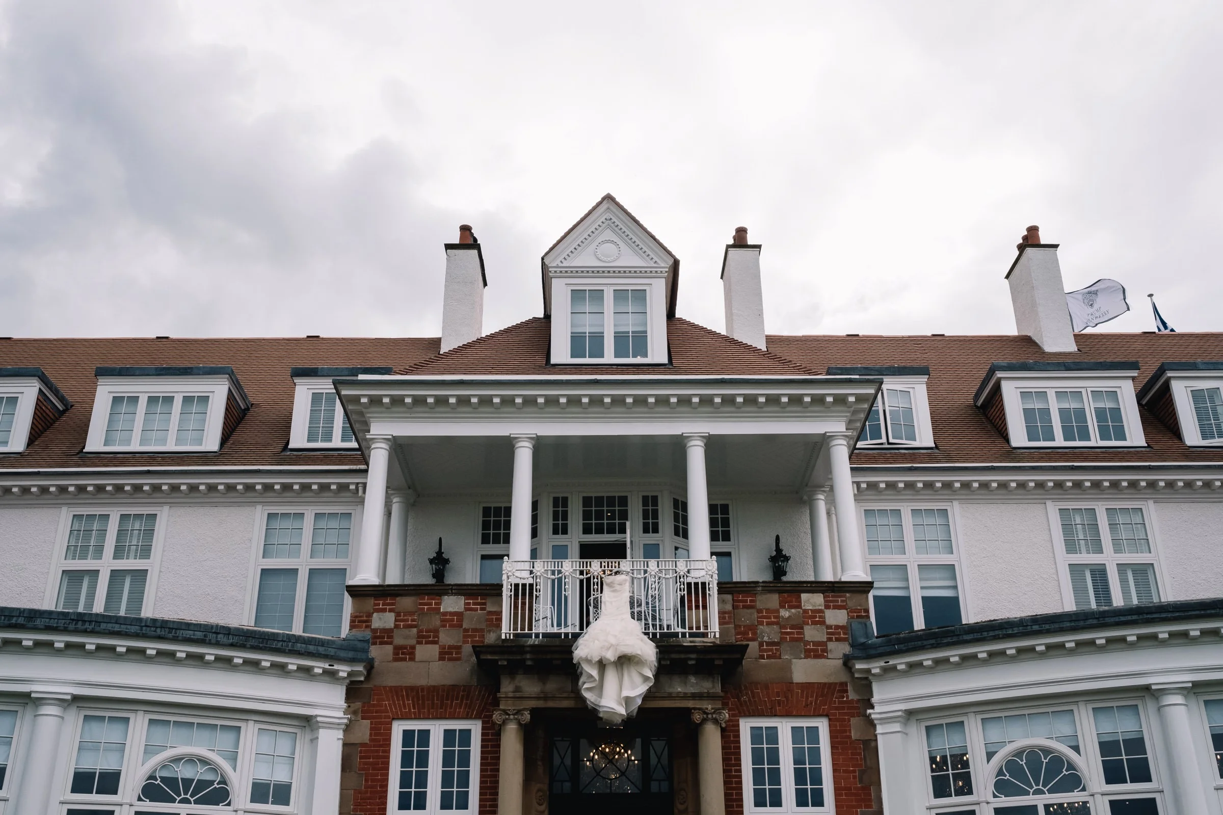 Wedding dress hangs from balcony