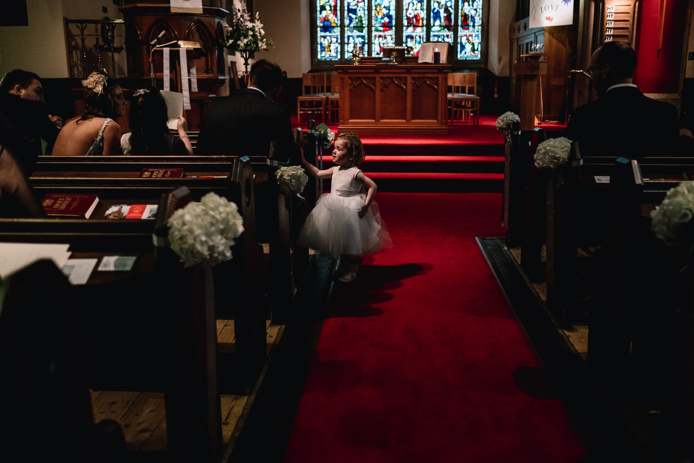 Young wedding guests stands in aisle