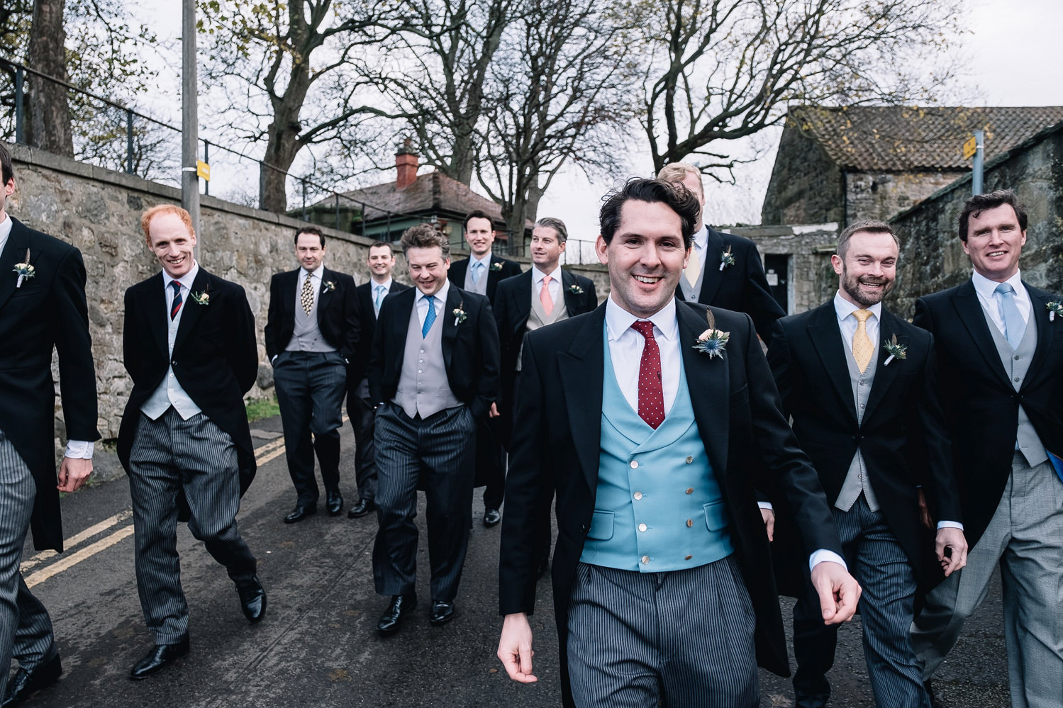 Groomsman walking wearing morning suit