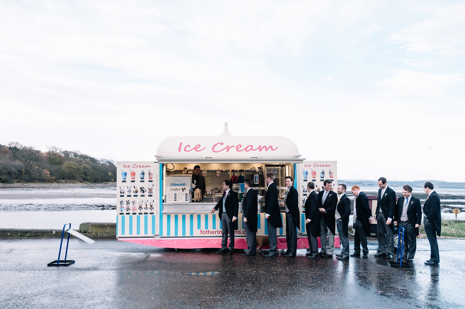  groomsmen all wearing morning suits lining up for ice cream 
