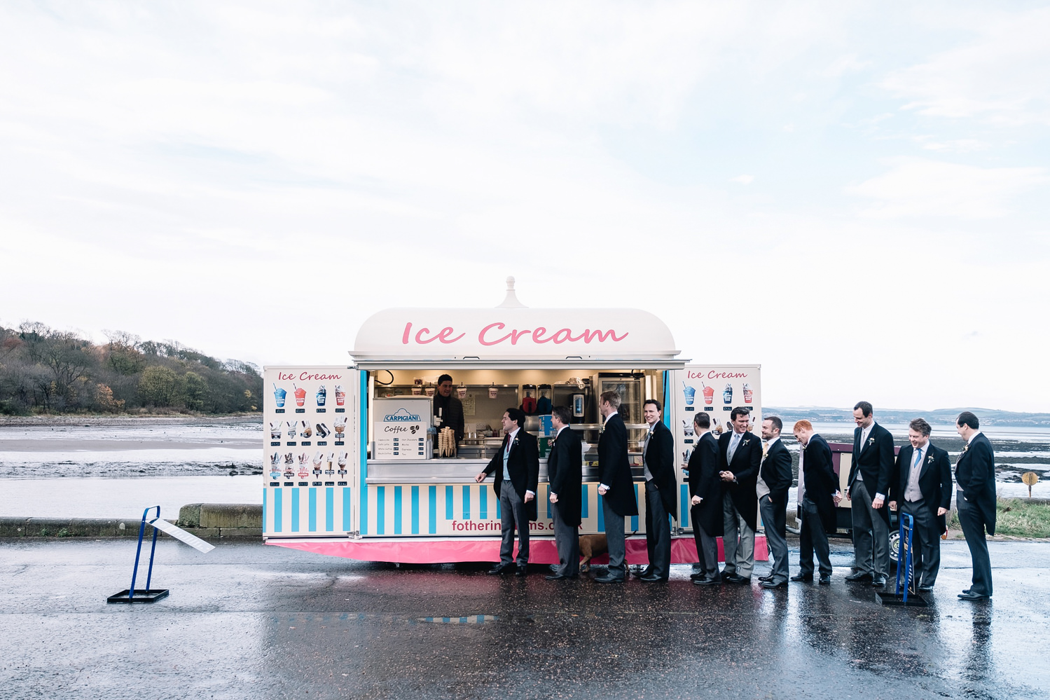 groomsmen all wearing morning suits lining up for ice cream