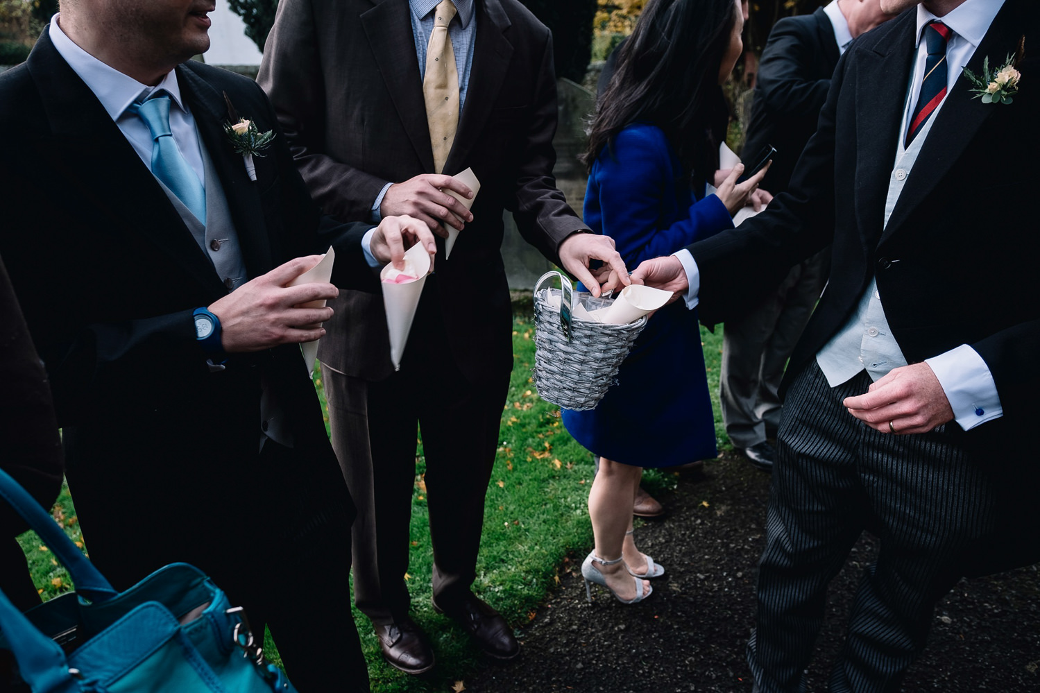  guests hold confetti cones 